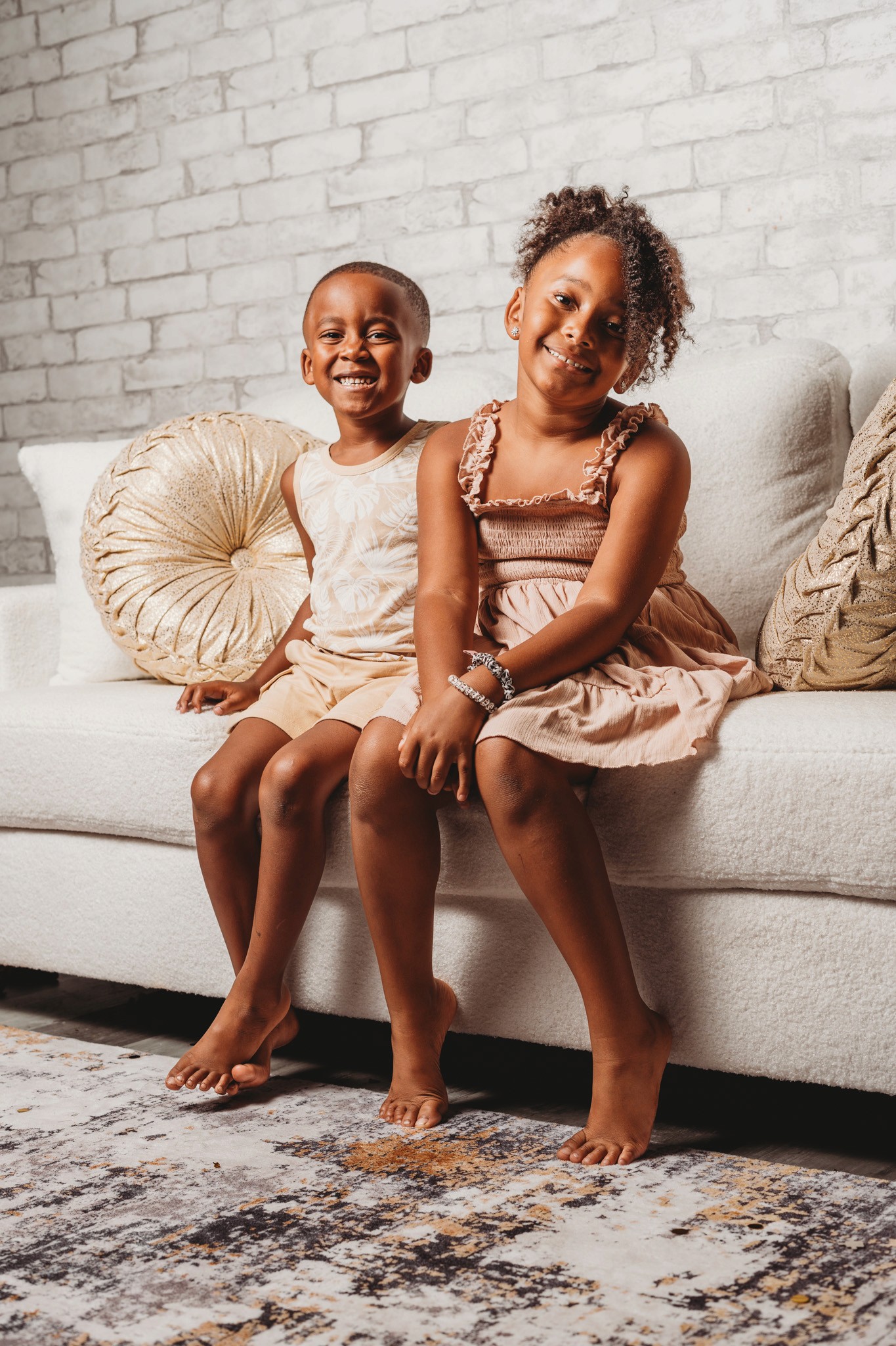 studio photography of two young girls on a couch
