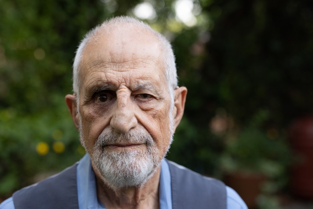 Bubjan with book and speaking to camera