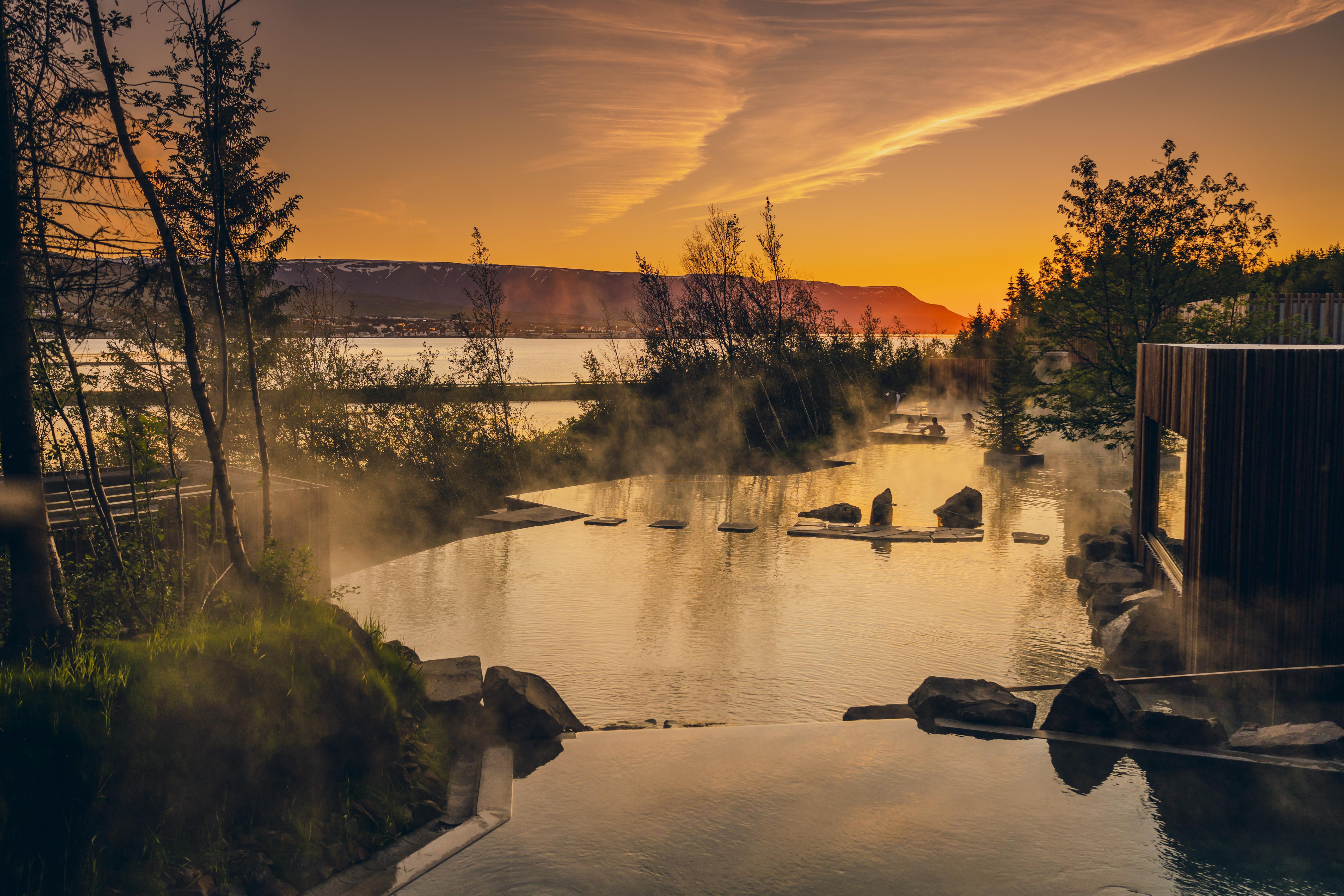 Forest Lagoon near Akureyri with warm geothermal water, forest surroundings and mountain views