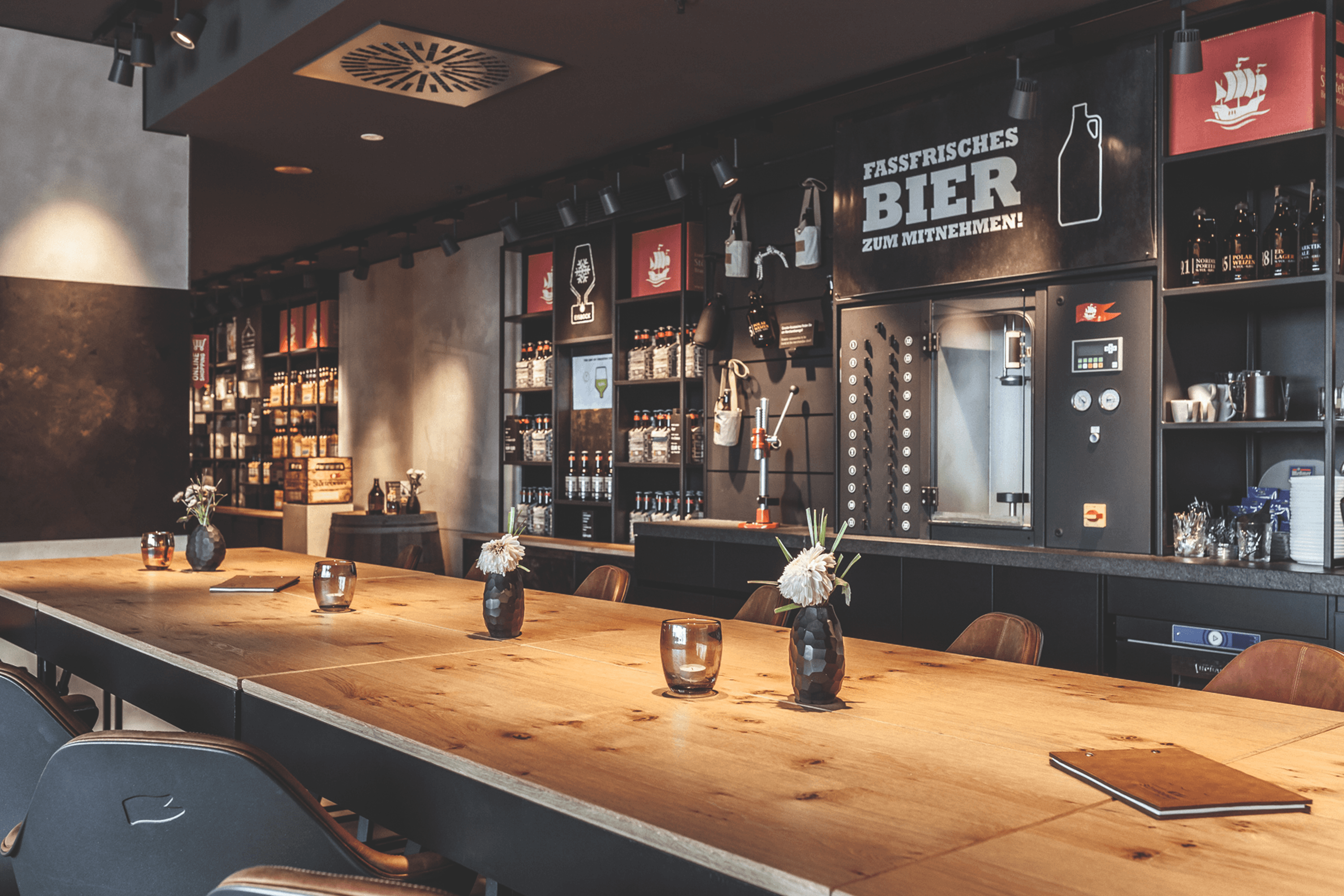 Bar interior with long wooden table and beer-themed decor