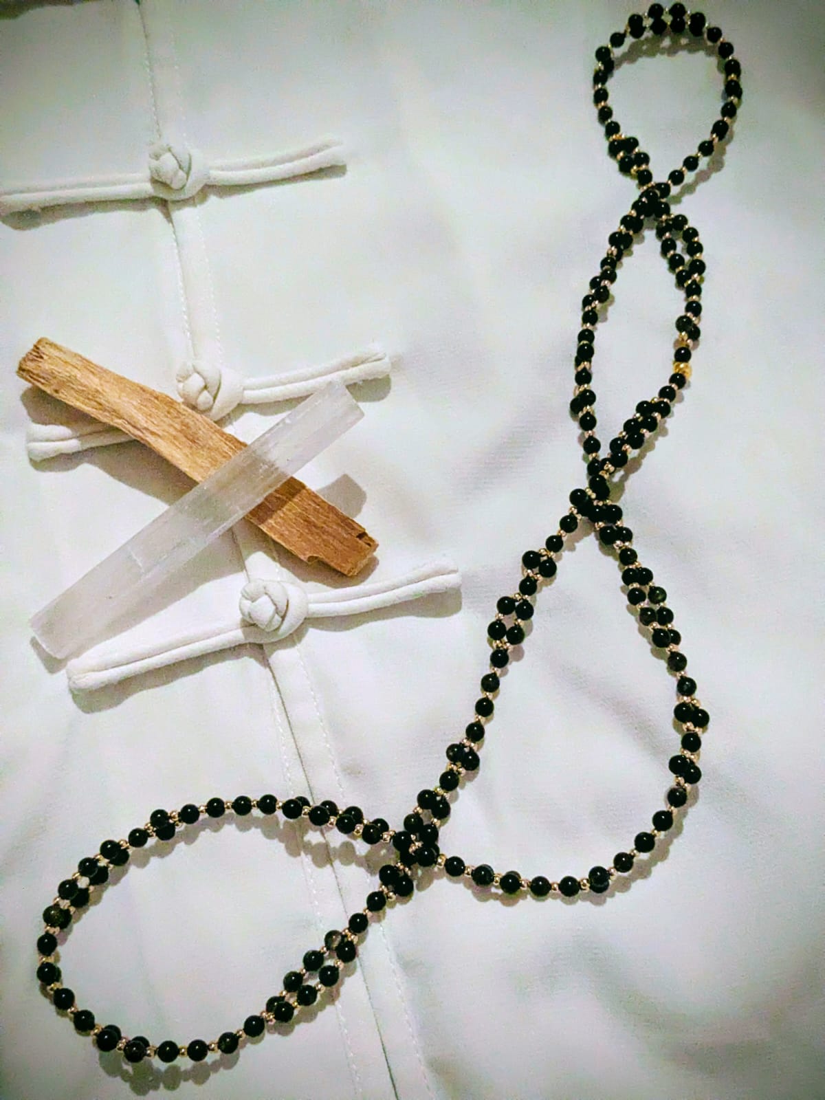 A young woman with wet hair, leaning back in a bath with her eyes closed. The sunlight reflects off the water, creating a serene and tranquil atmosphere.