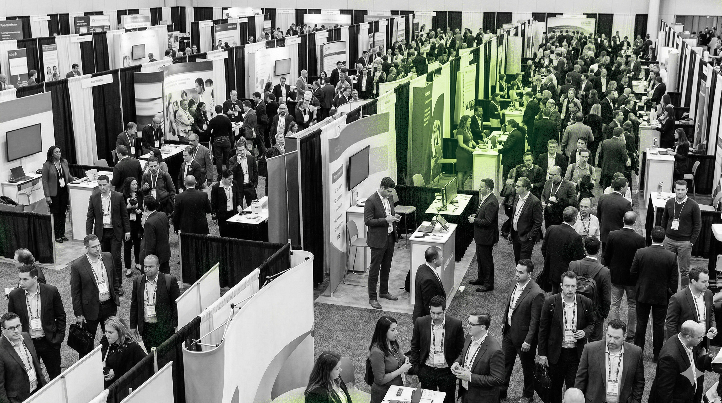 Busy convention hall with exhibition booths and professionals networking at a trade show.