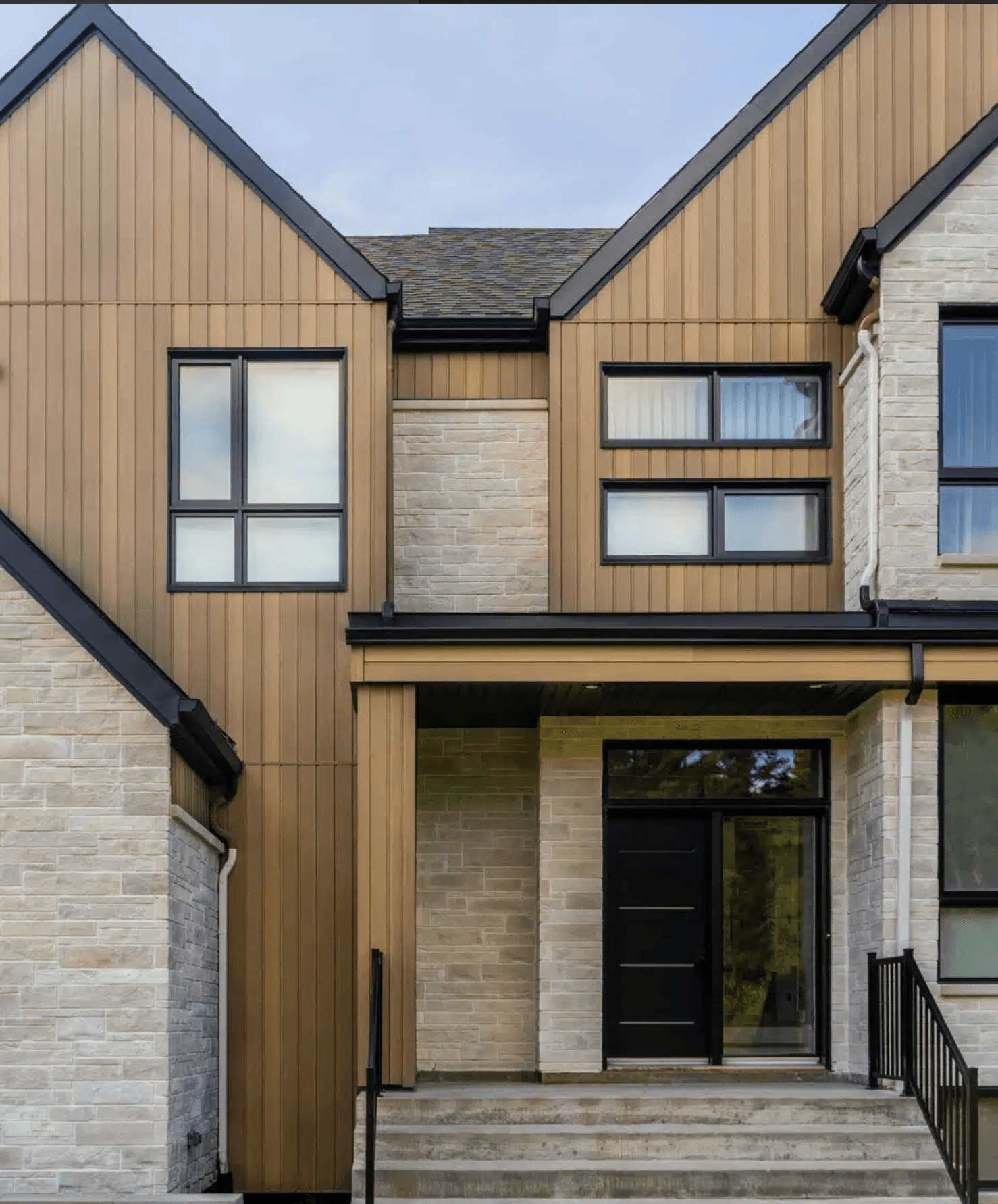 Norwood steel architectural siding with stone detailing and contemporary windows and doors