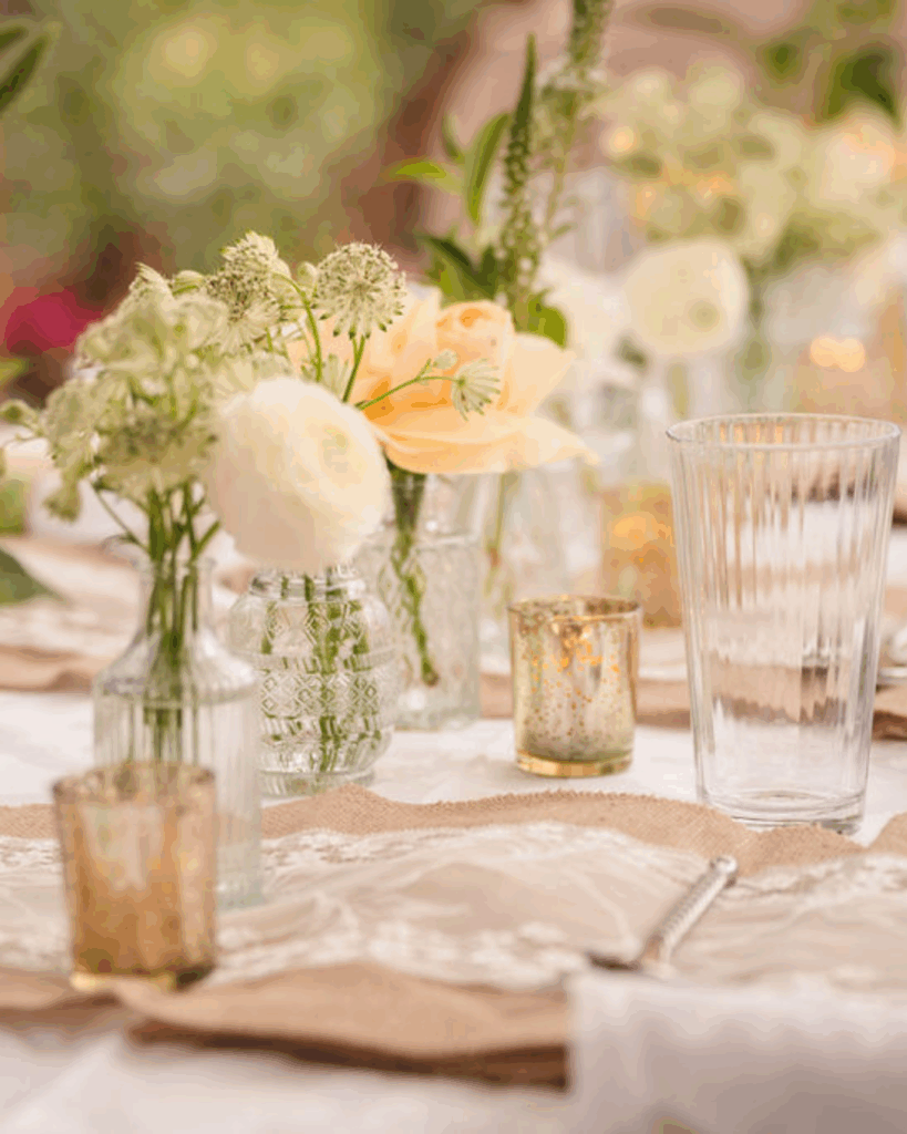 Flowers and place settings arranged on a reception table