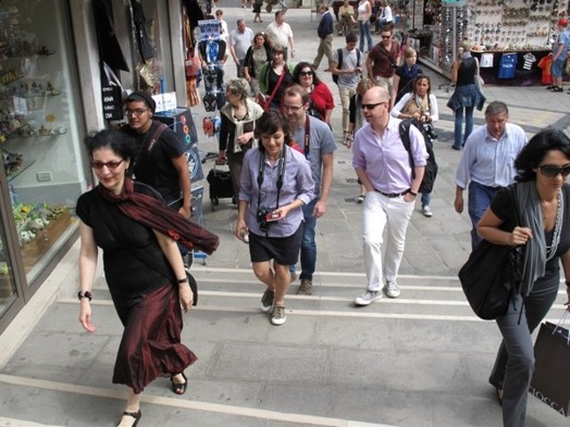 A photo of a group of people climbing some street stairs.
