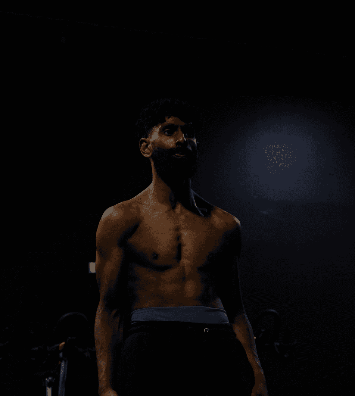 Dramatic portrait of a male athlete with strong directional lighting, representing Konvex Studios’ photography service.