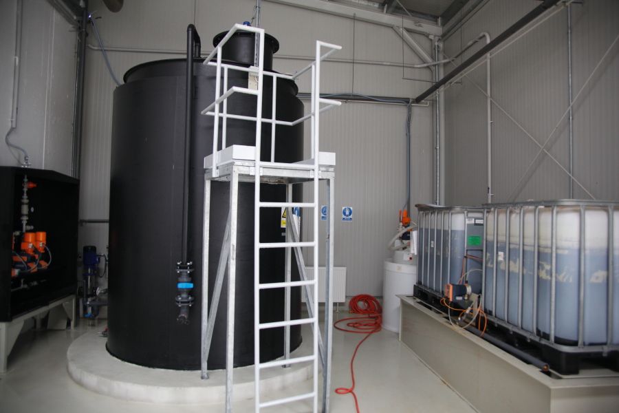 Chemical dosing tank and IBC containers in the treatment building at the DEKO-FOOD wastewater plant, Debrecen, Hungary