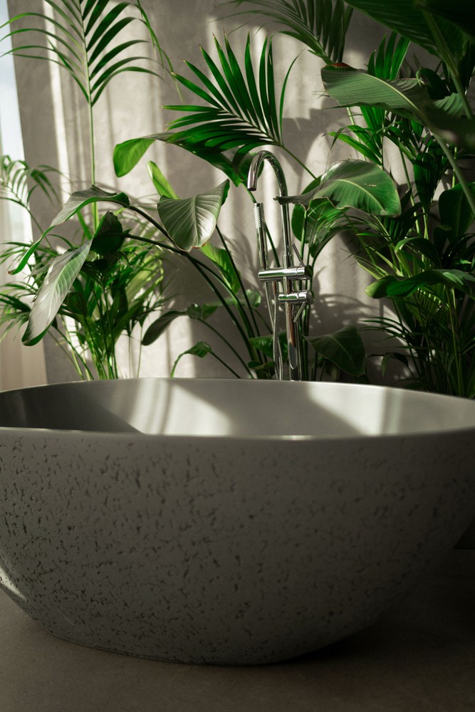 Luxury stone bathtub amidst lush plants, embodying sensual boudoir art.