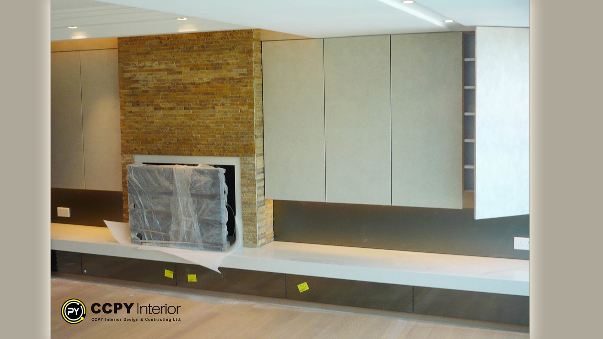 A minimalist fireplace with striking black marble veins integrated into a sleek media wall within a Mount Pavilia luxury house interior.