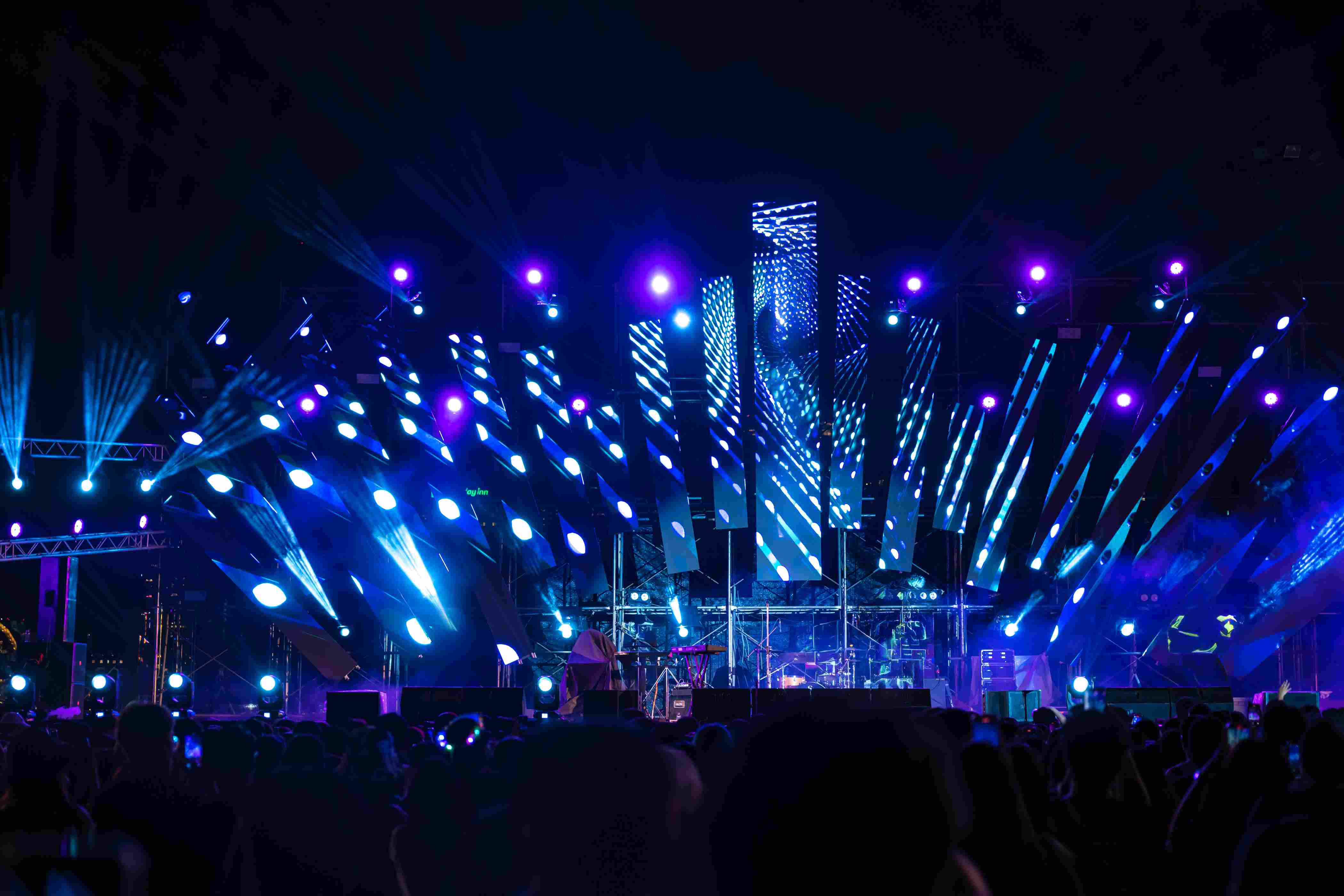 concert festival stage with a big crowd and immersive lights