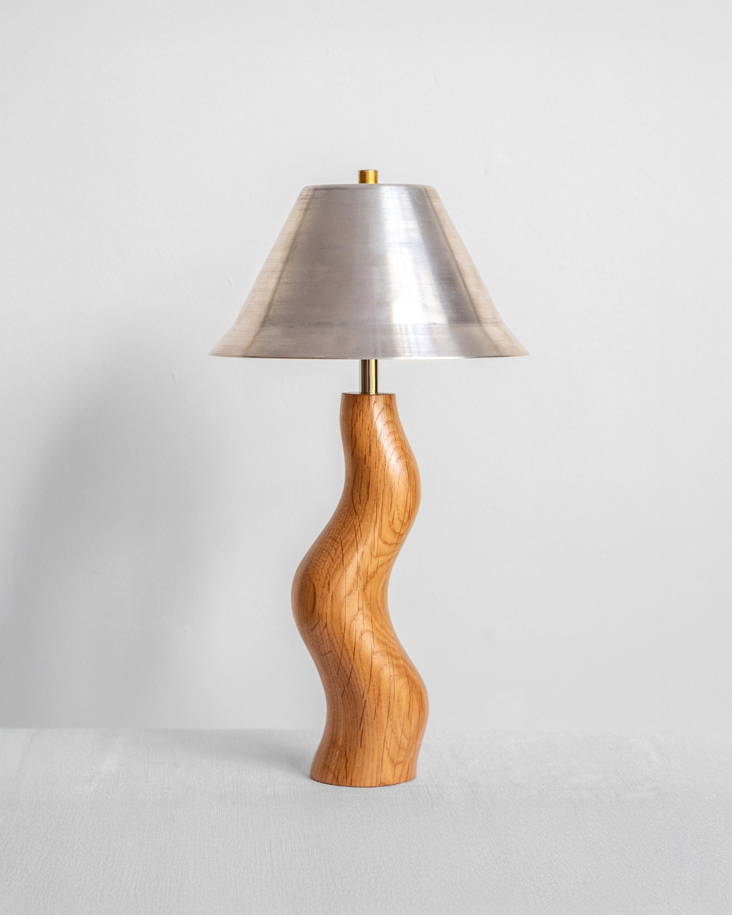 Dancing Desk Lamp with Oak base and Aluminium shade on a light grey background with UK, EU and US/CA wiring available Wilkinson & Rivera