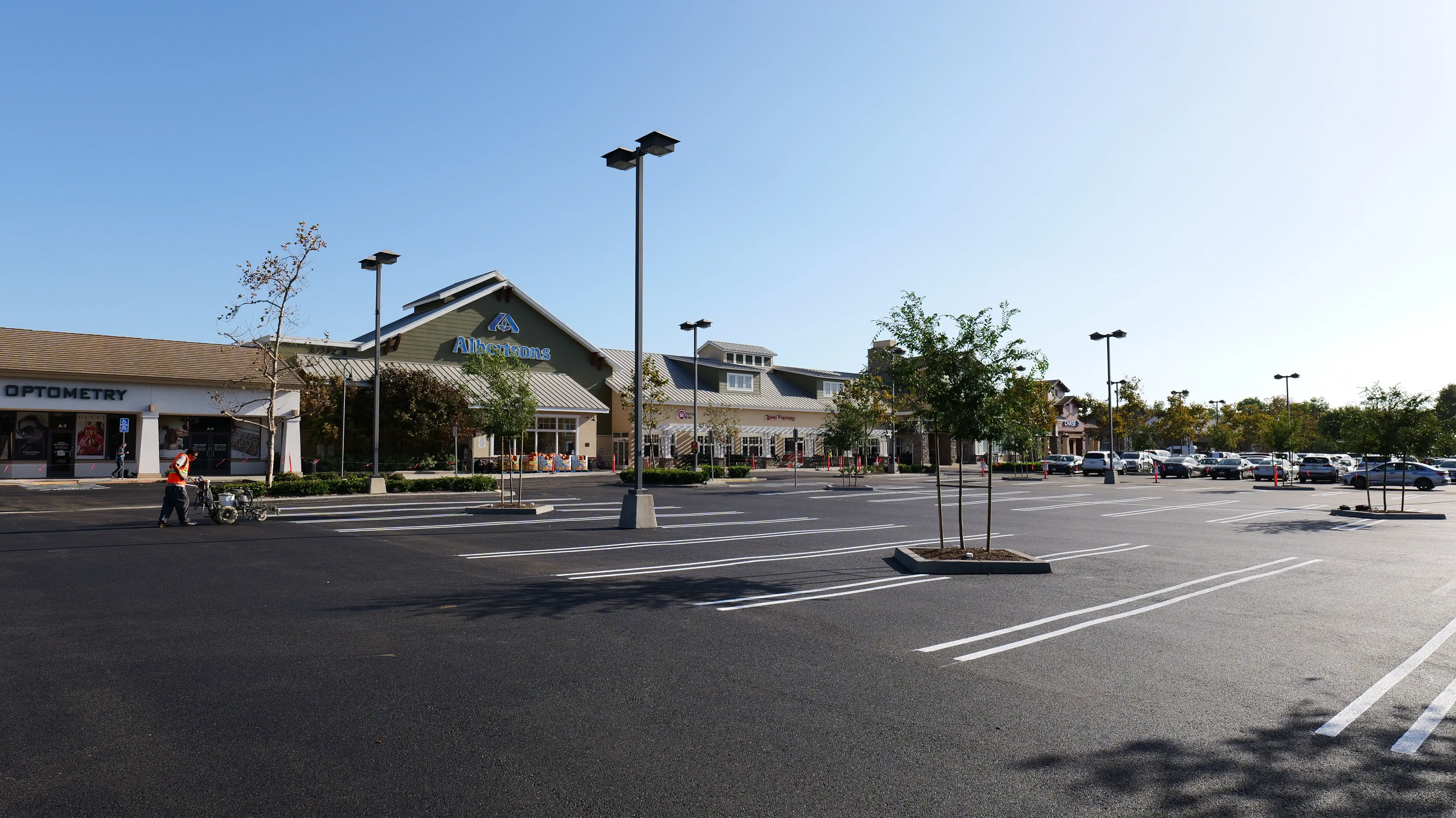 Photo of freshly sealcoated asphalt shopping center parking lot