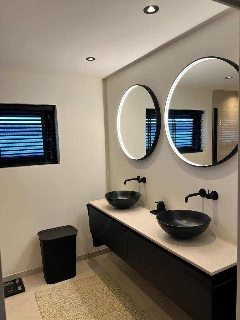 Salle de bains sous combles : baignoire îlot, double vasque bol, plafond bois, éclairage encastré — Luxembourg.