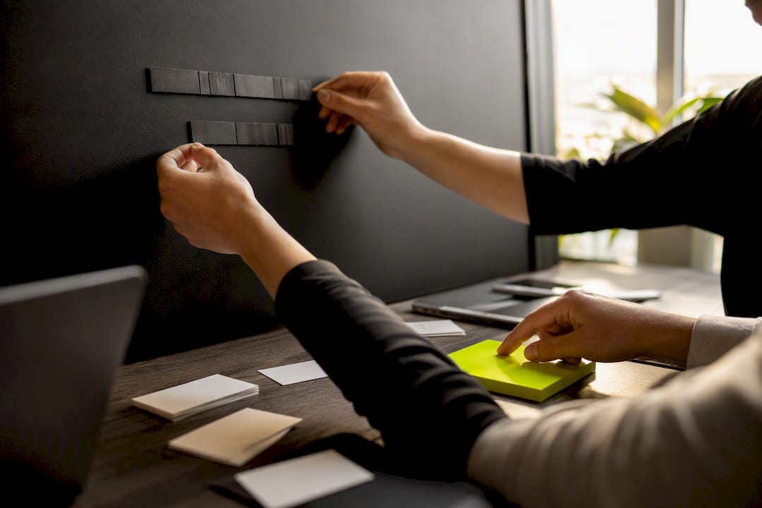 Hands arranging headline and CTA elements