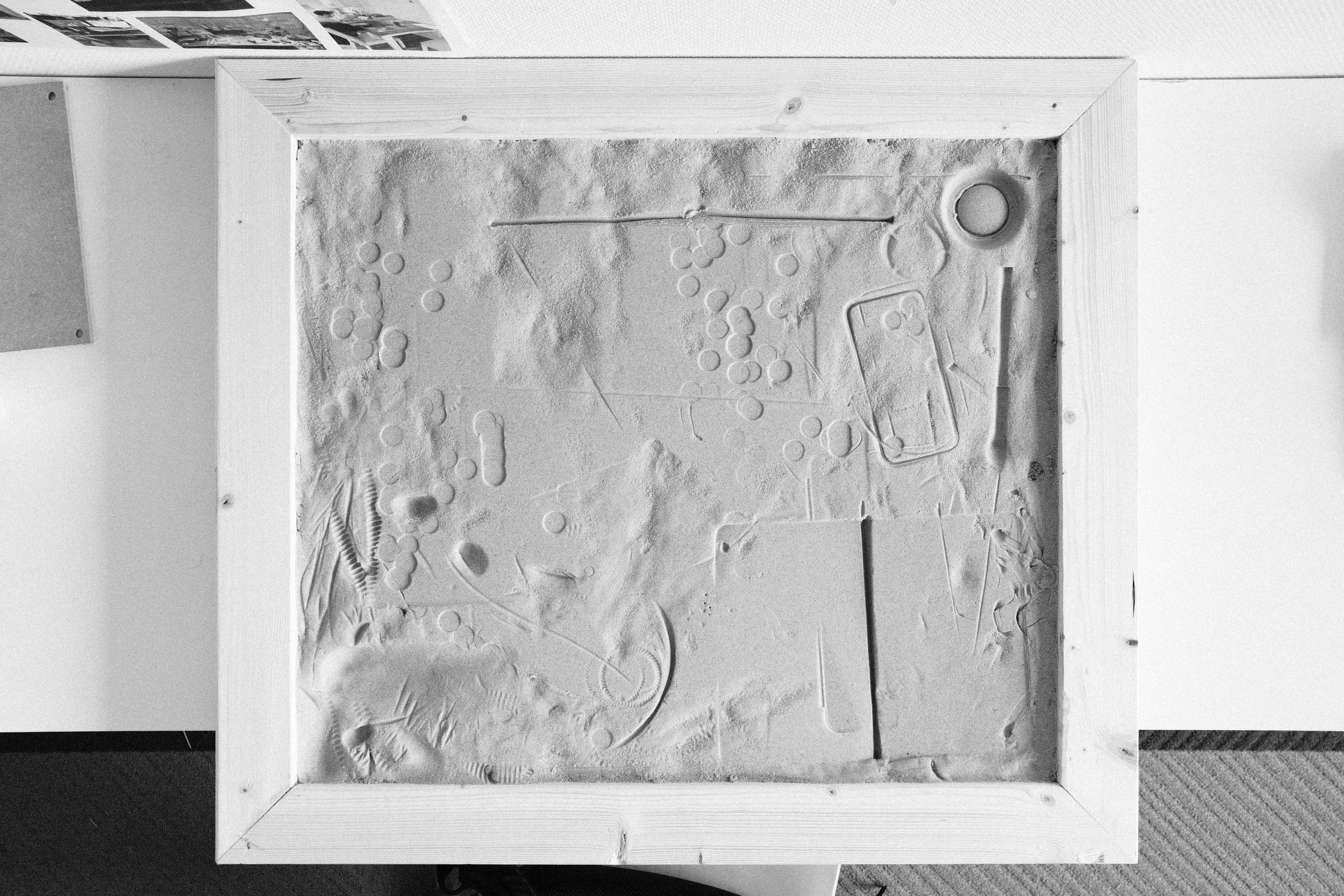 Tabula plaster surface marked with impressions of everyday objects