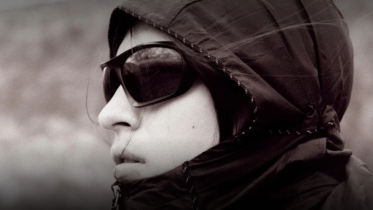 horizontal portrait of a woman in running glasses.