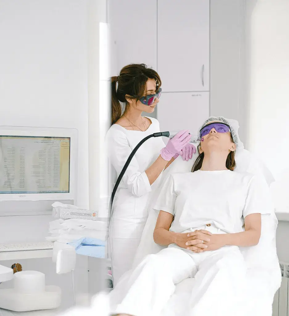 Aesthetic professional performing facial treatment with modern skincare equipment, representing innovation and safety in medical aesthetics.