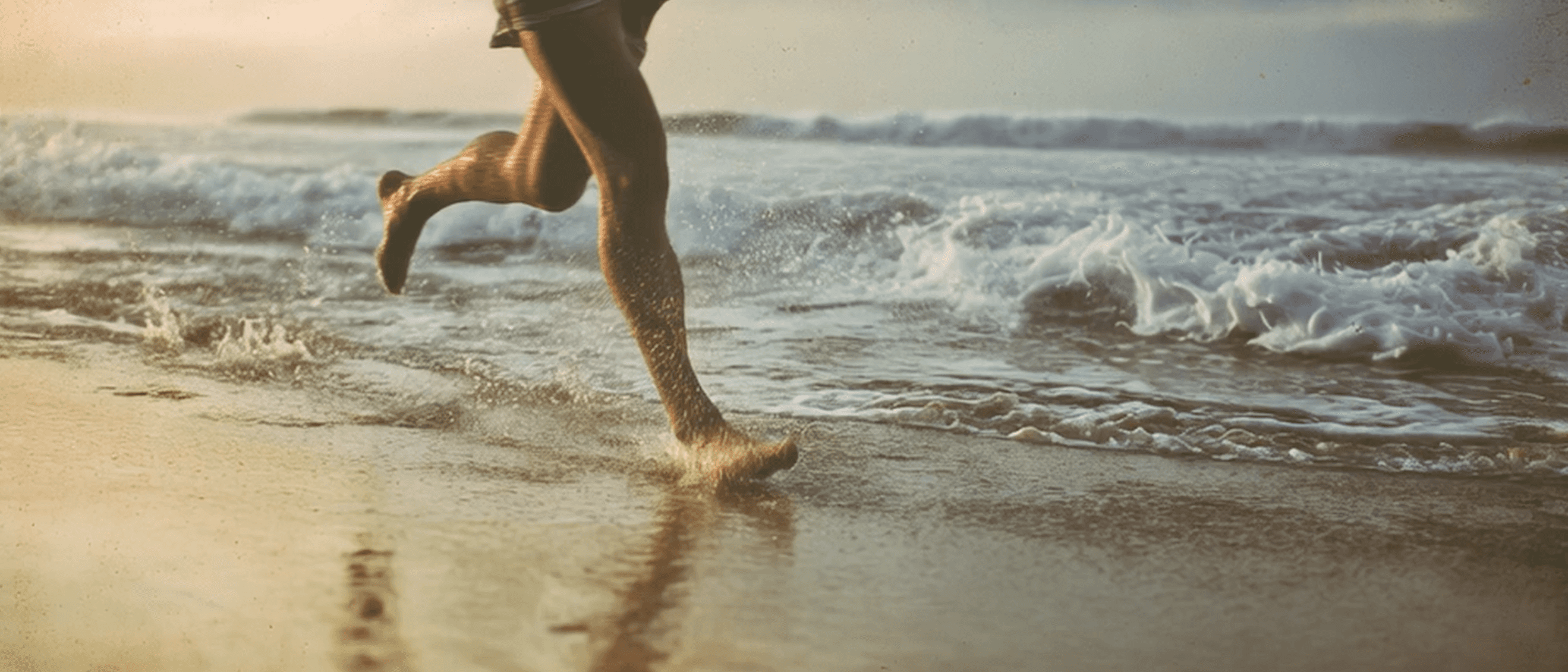Barefoot figure running along the shoreline, waves brushing their feet — a moment of freedom and joy on the French coast.