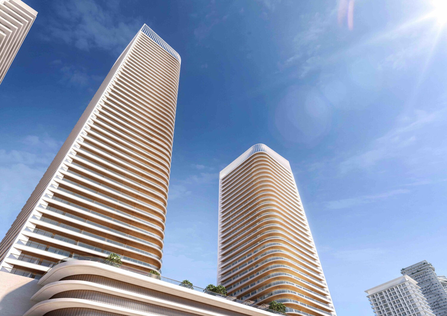 Moderne Hochhäuser am EMAAR Beachfront in Dubai mit klarer Architektur und blauem Himmel – Darstellung von The Cove mit exklusiven Interiors by Elie Saab.