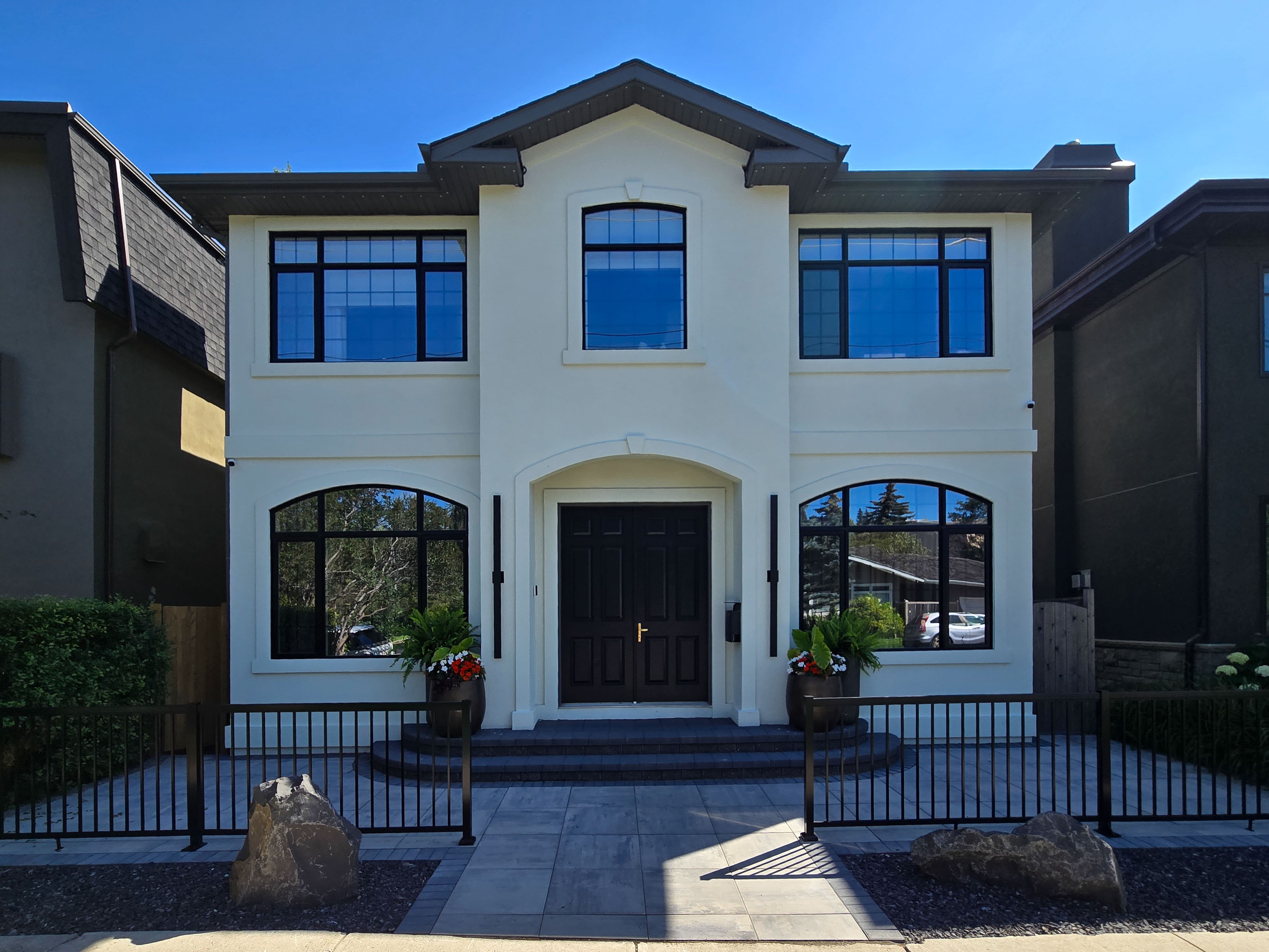 Image of KHD Homes luxurious two-story white house with black trim and modern design exterior layout.