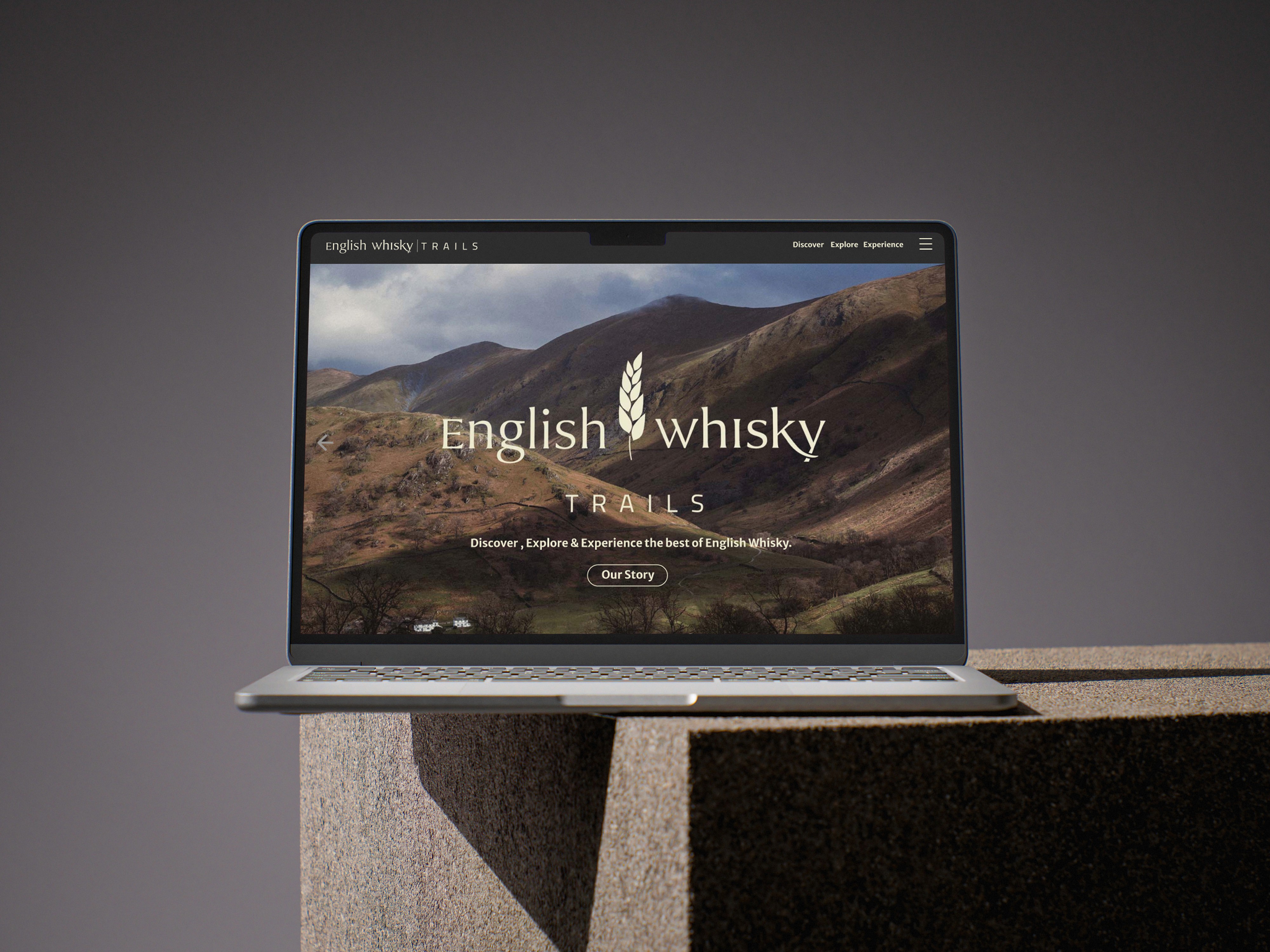 English Whisky Trails Project graphic of a laptop feturing the new visual identity and logo