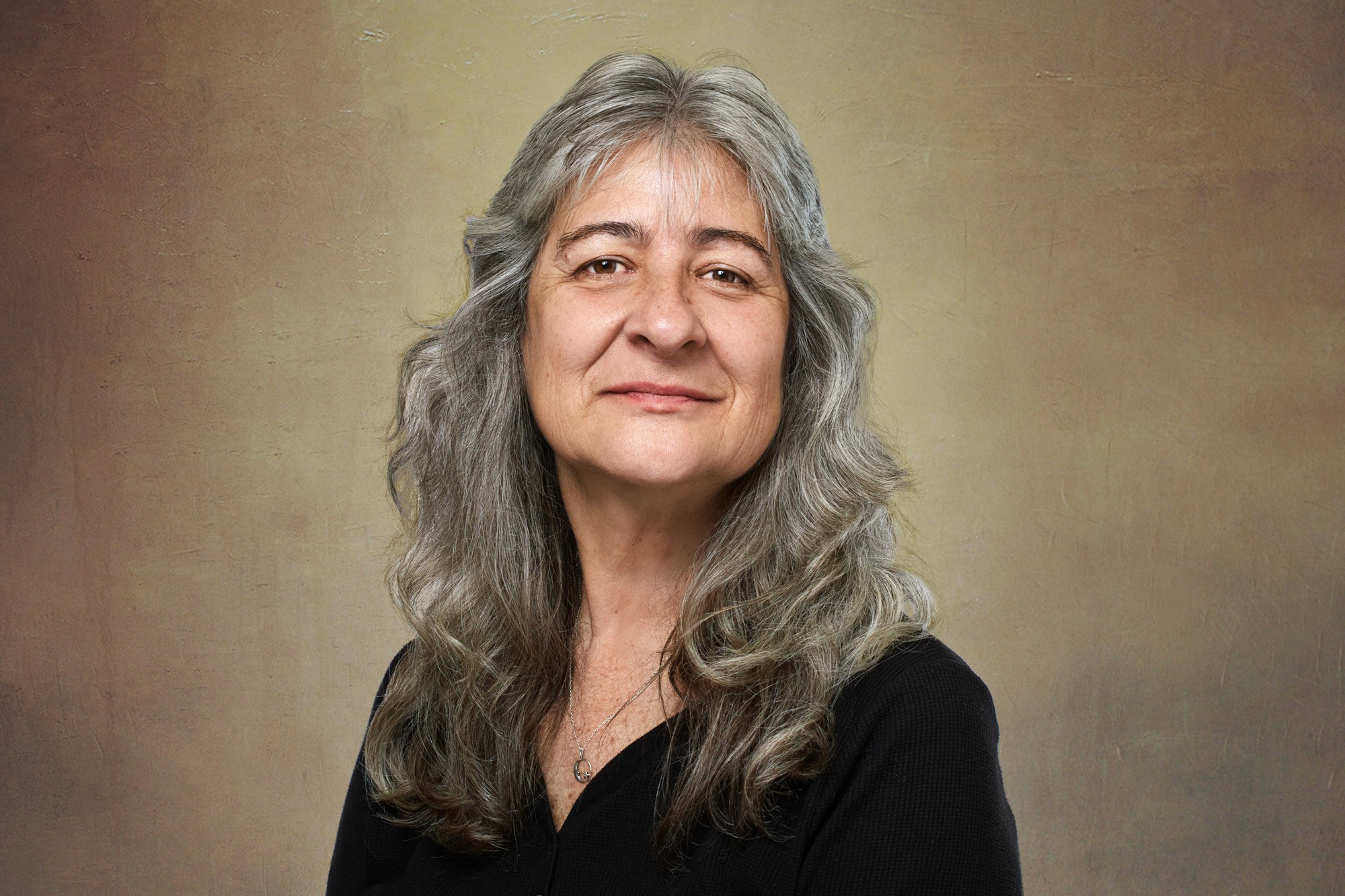Clean studio headshot of blonde white woman with center part