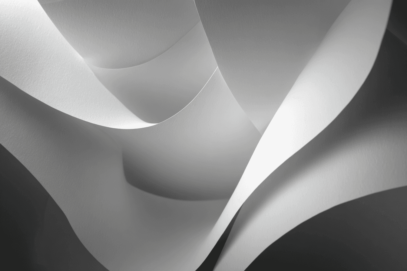 Abstract design featuring smooth, curved shapes in shades of gray, creating a fluid and dynamic composition.