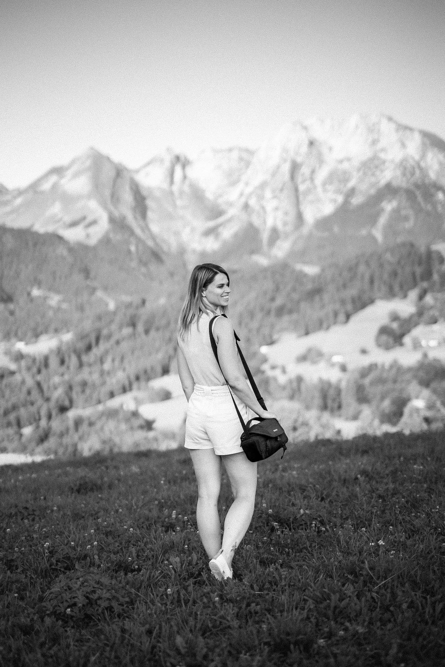 man alone on paddle in front of a montainous mediterranean village
