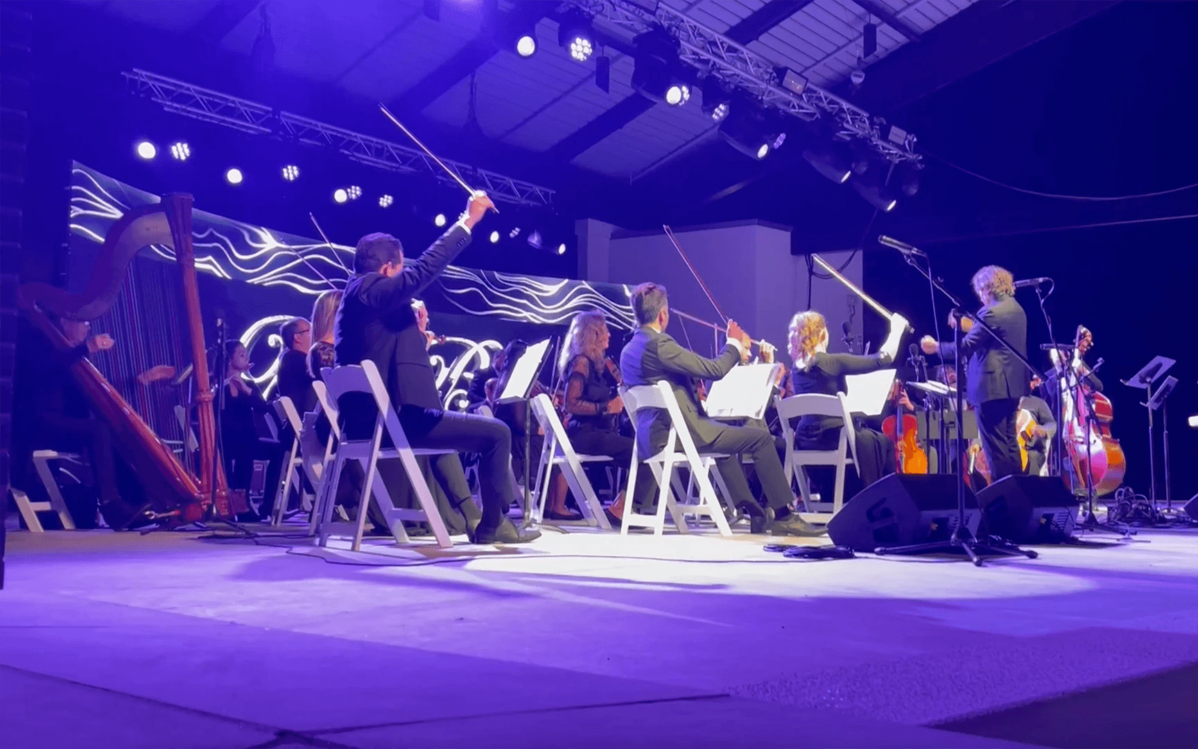 Andrew Lipke conducts musicians at private event