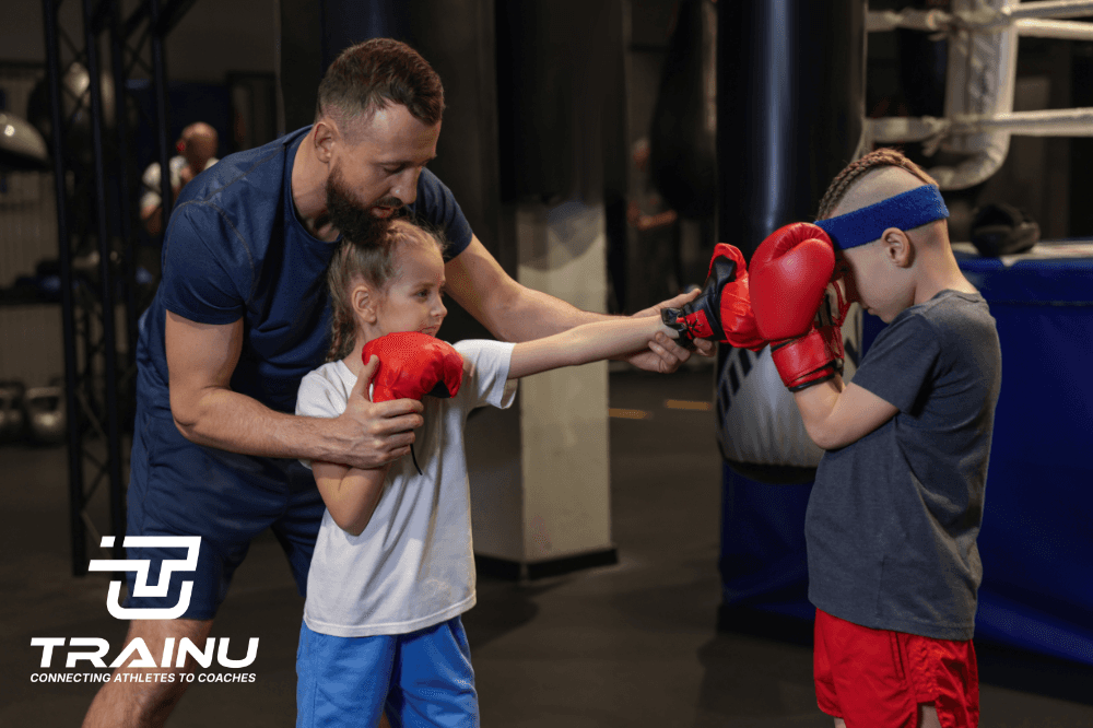 Focused man wearing a cap working on a laptop at a modern desk in a minimal office setting.