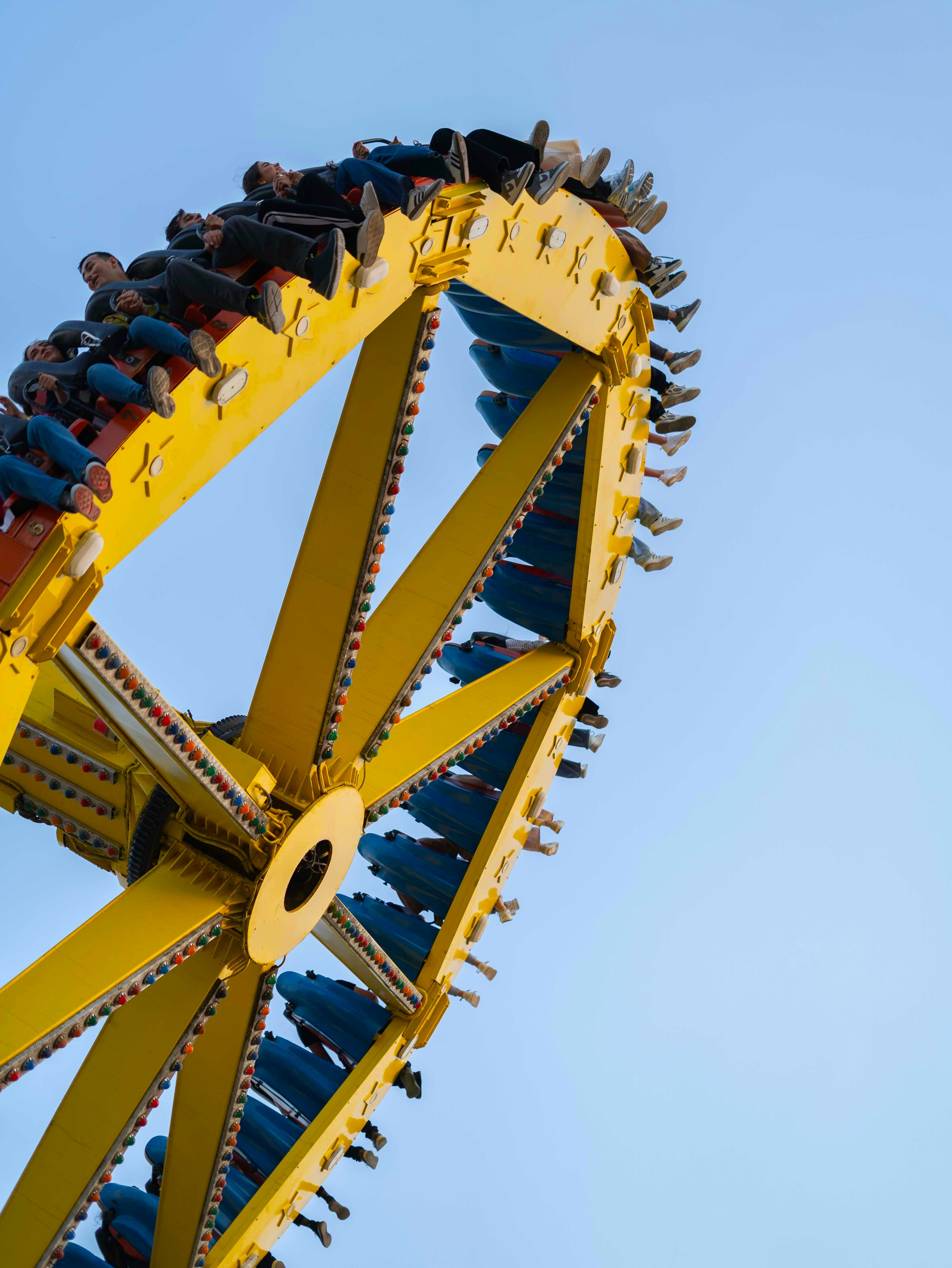 A roller coaster in the middle of a blue sky