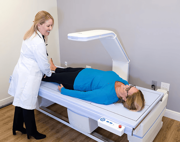 Dr. Migdalia Merida performing a DXA body composition scan as part of personalized health management.
