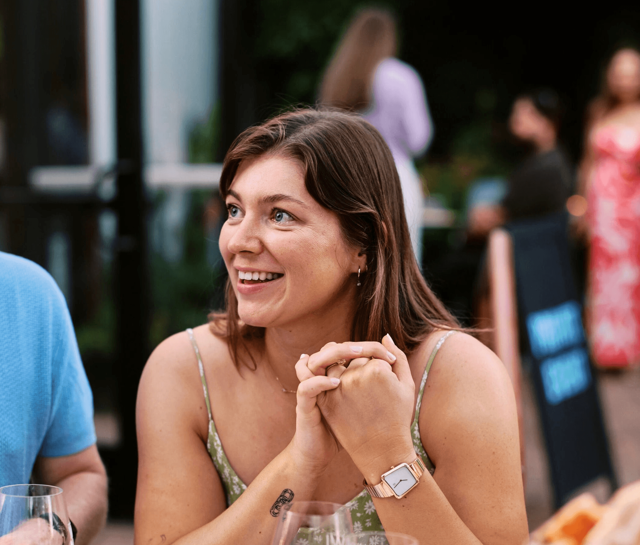 A thoughtful young person with dark hair gazes to the side, captured in soft black and white lighting.