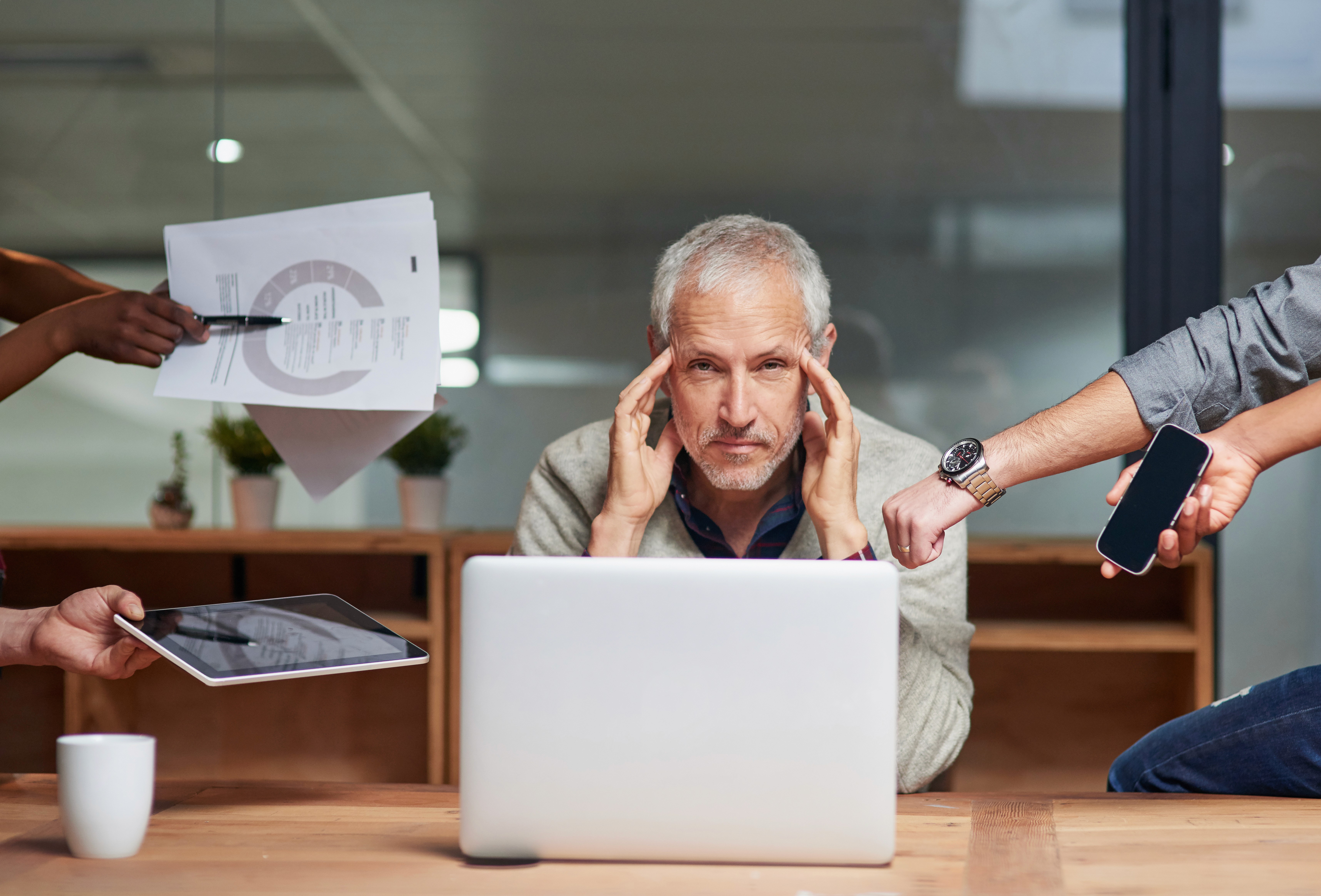Professionals analysing financial reports together, representing a business consultant focused on understanding revenue performance and outcomes.