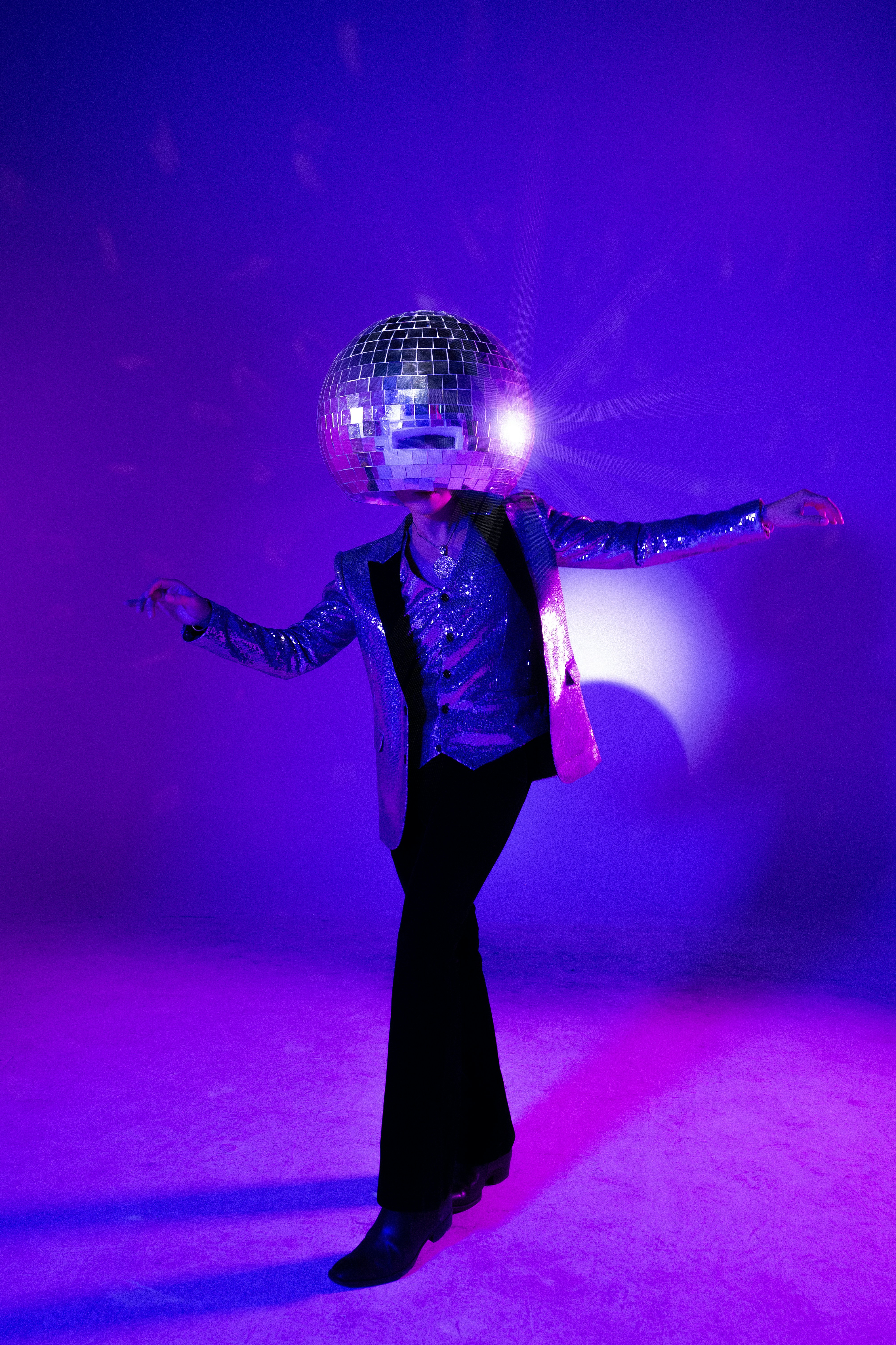 Disco ball-headed person strikes a pose.