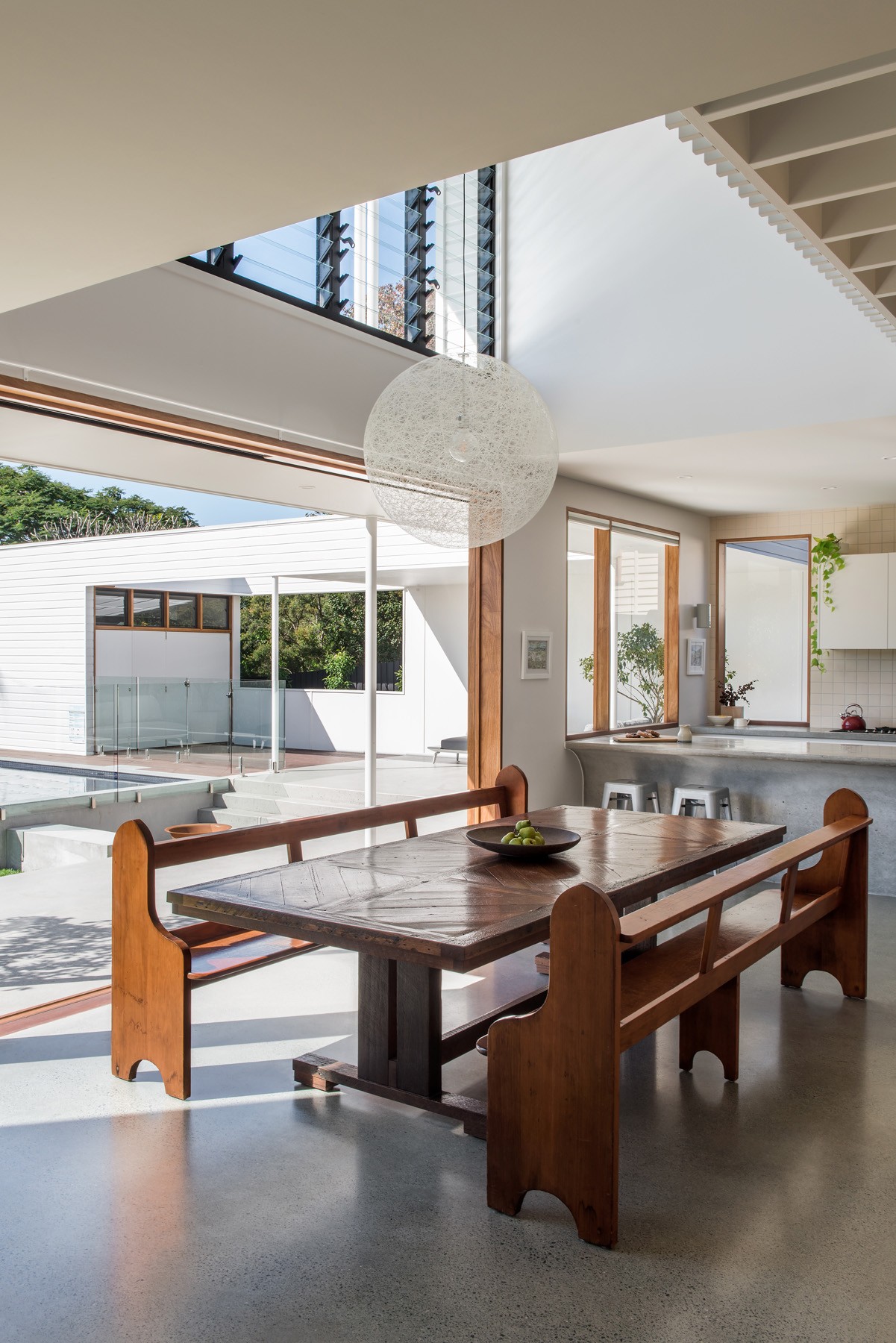 Open-plan living and dining space with sliding timber doors opening to the rear yard, reinforcing the home’s strong indoor–outdoor connection.