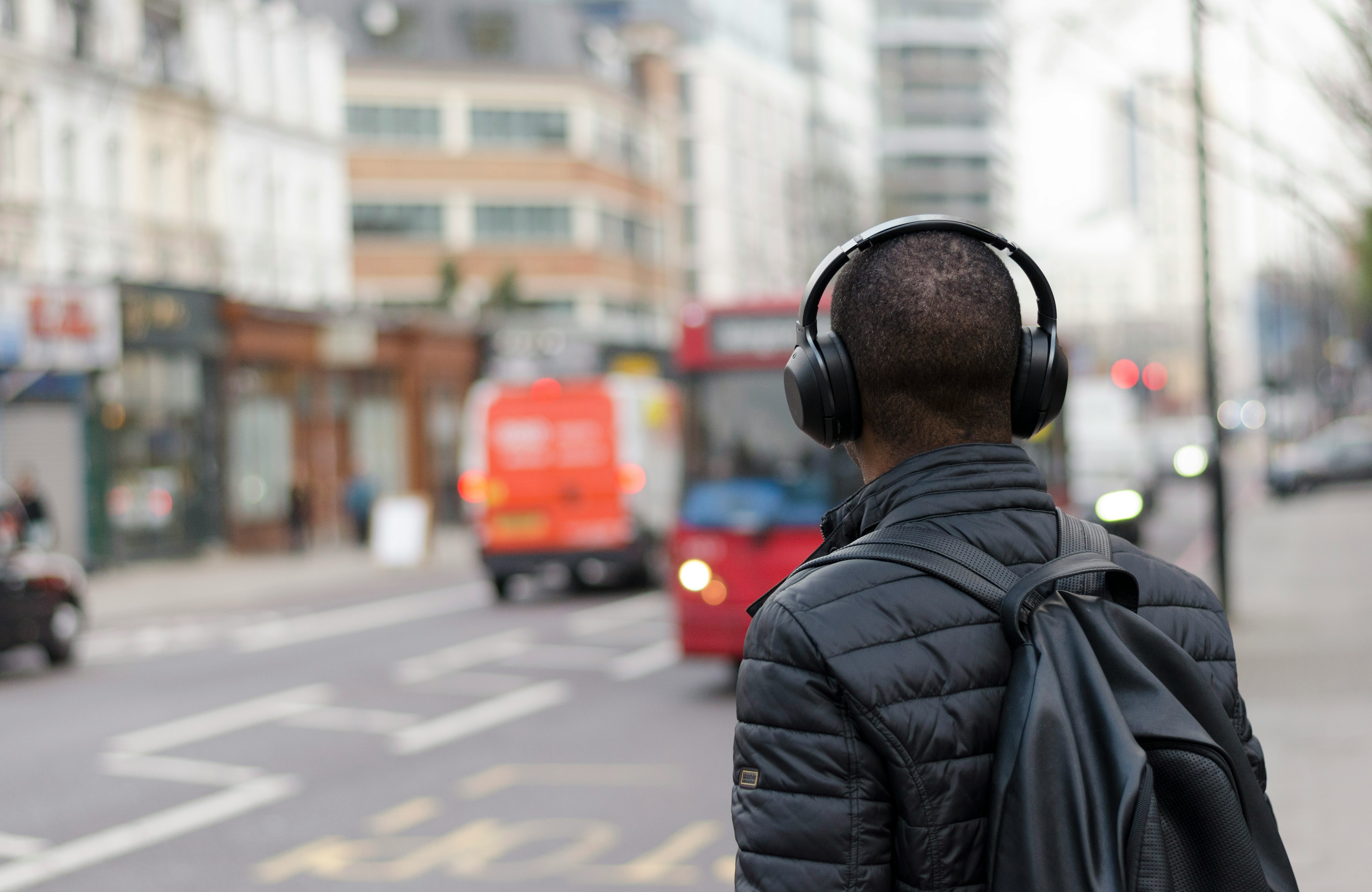 Person wearing Headphone Crossing Road- Free Reading Apps You Should Know