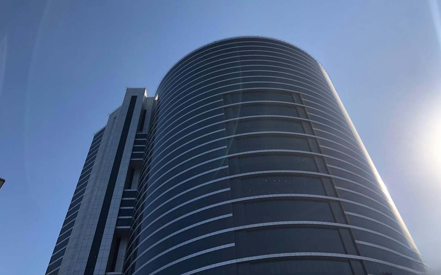 Low angle view of I-Rise Tower glass facade, a prime location for real estate investment and office space.