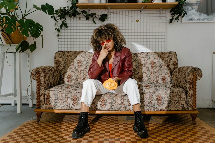 a person sitting on a couch with a laptop