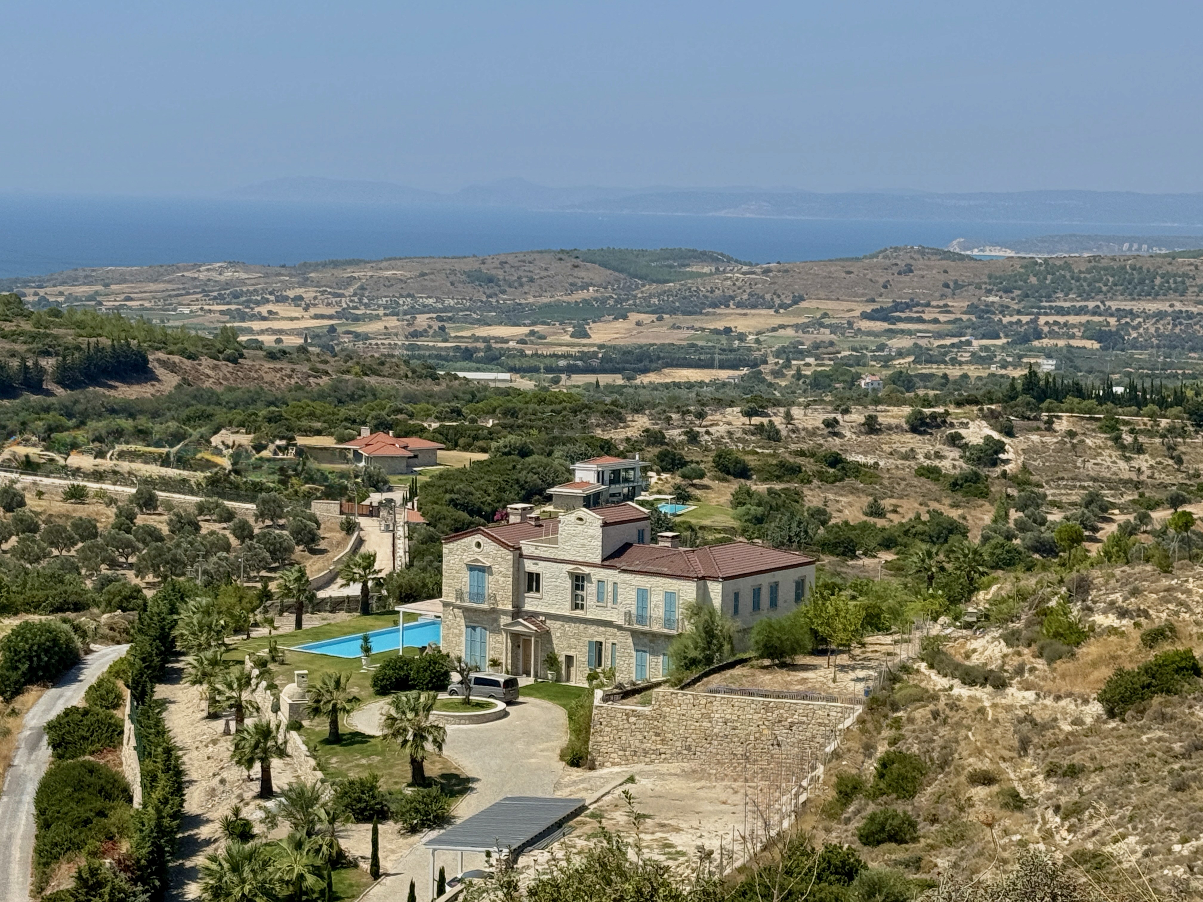 Stone villa with infinity pool among olive groves above Çeşme, Aegean Sea and Chios on the horizon