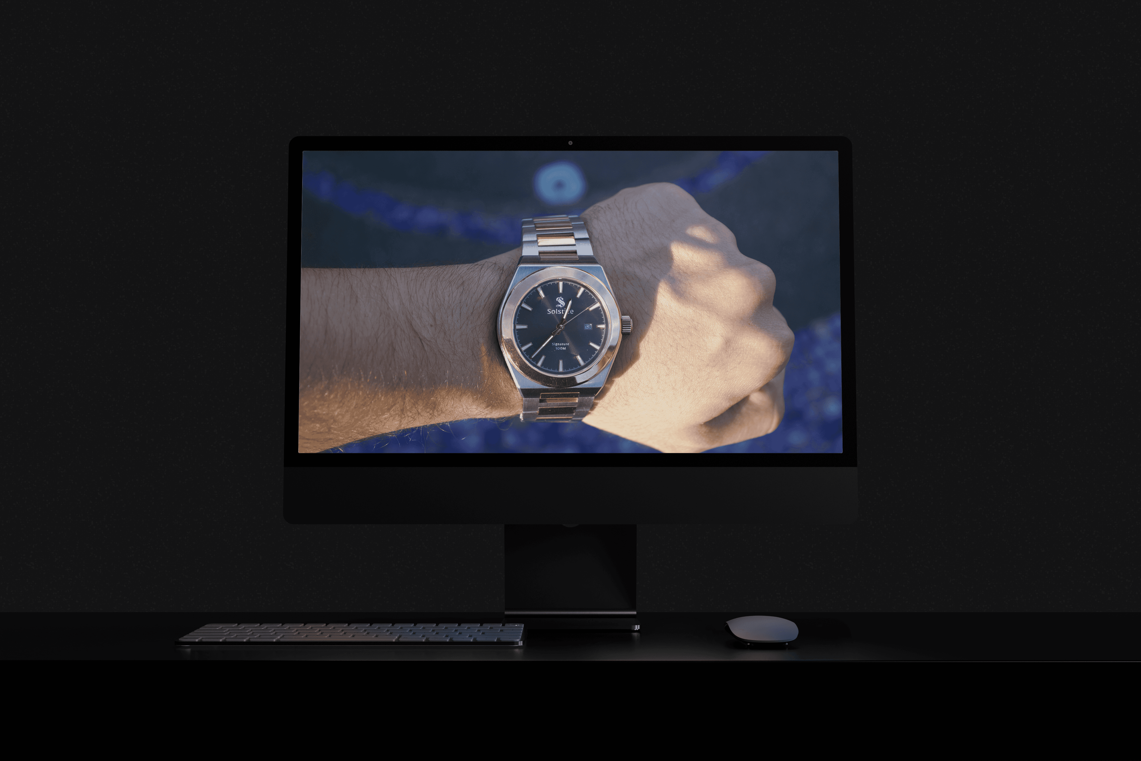 a dark room with a large monitor showcasing a watch on a wrist