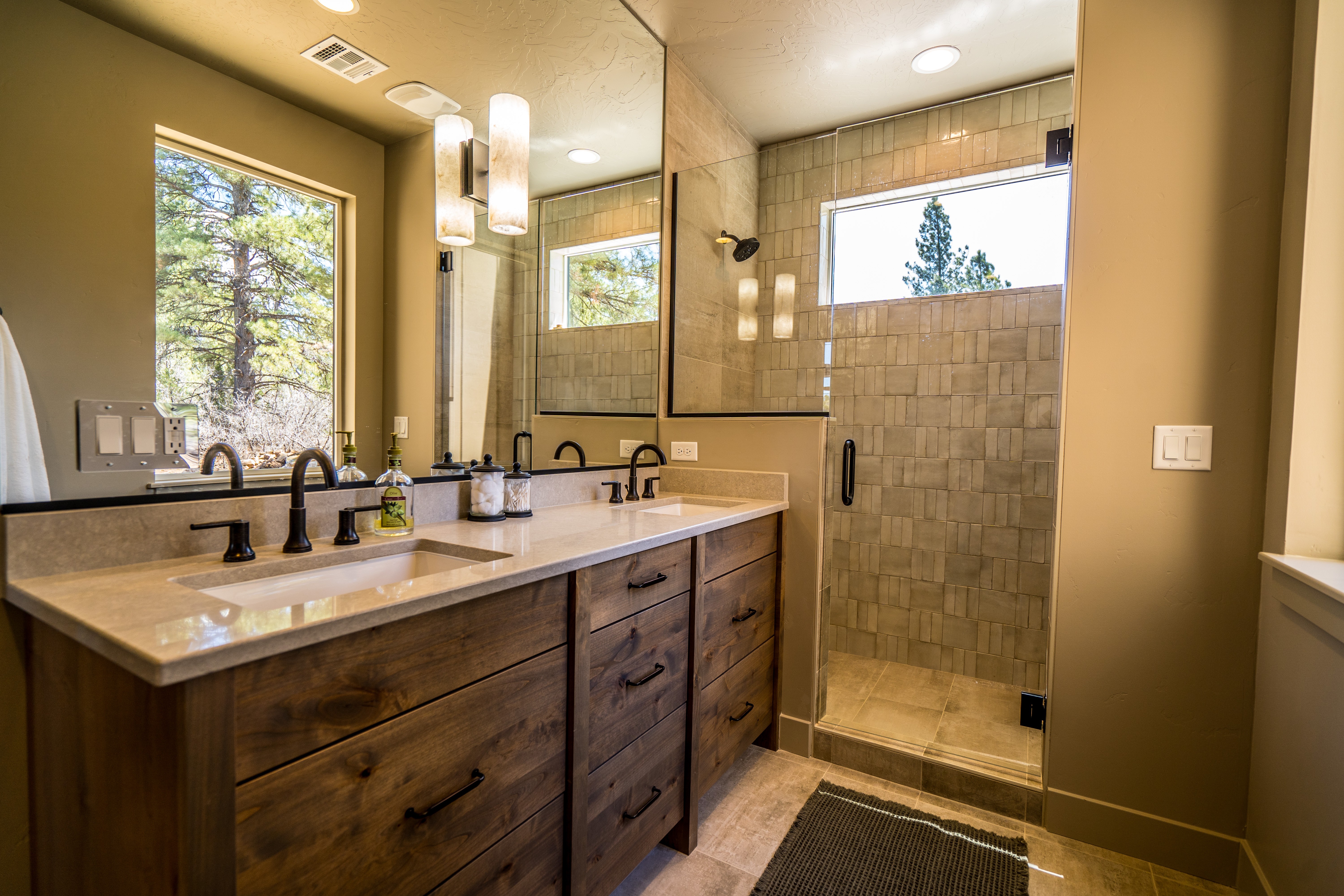 Bathroom with wood cabinets and tile shower walls in Orderville, Utah.