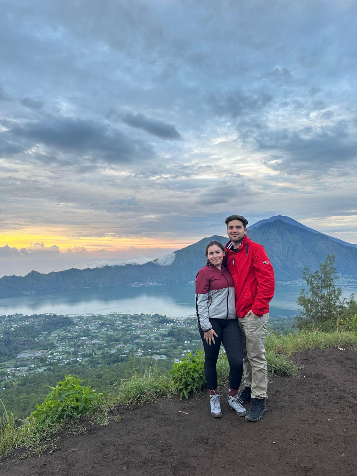 Close-up of two hands gently clasped, one wearing a sparkling engagement ring. The soft lighting and pastel nails evoke a sense of romance and intimacy.