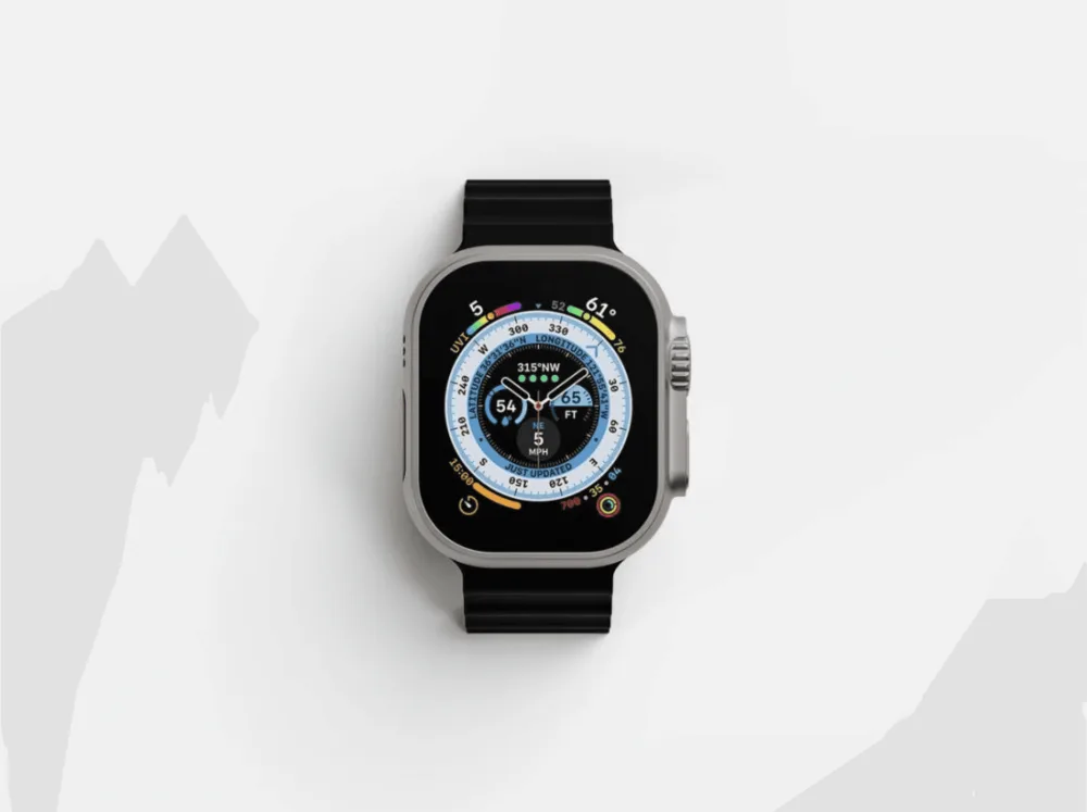 Mockup of a modern smartwatch with a titanium case and black band, displaying a colorful compass interface with detailed metrics. The watch is centered on a clean white background.