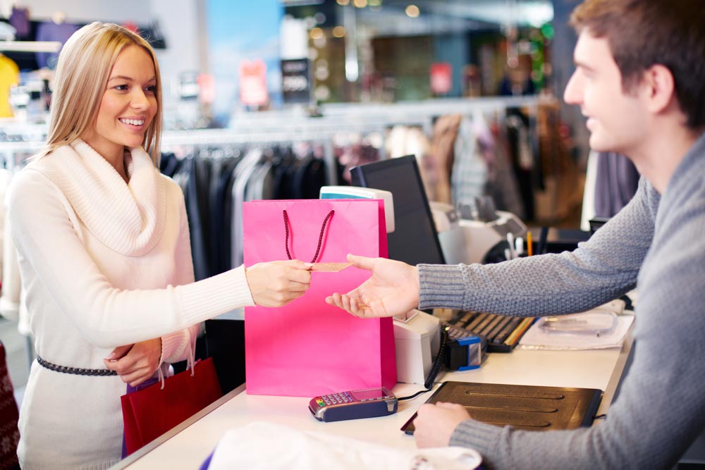 Customer completing an in-store purchase, representing how strong CRM strategies support repeat buying and seamless TikTok Shop seller experiences.