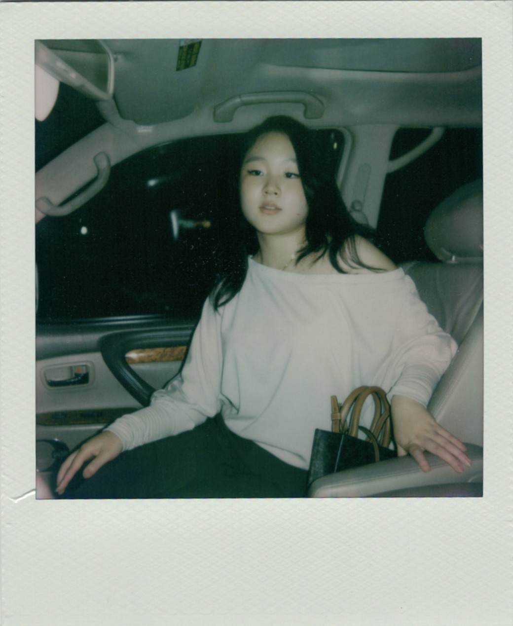 A smiling woman writing on a piece of paper in her home