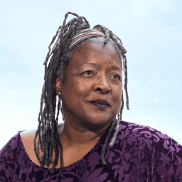 Possible member smiling and looking away from the camera.