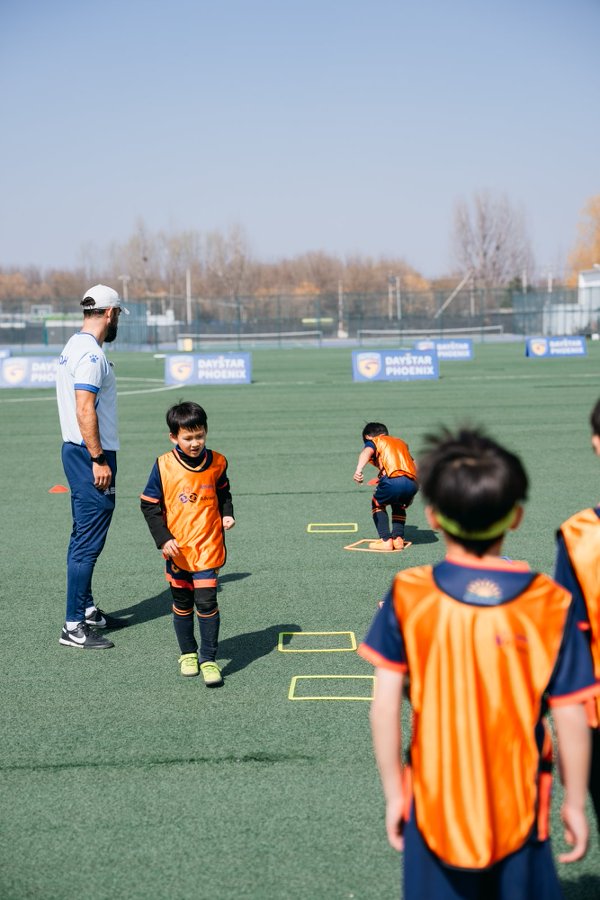 Football training session viewed through a mini goal