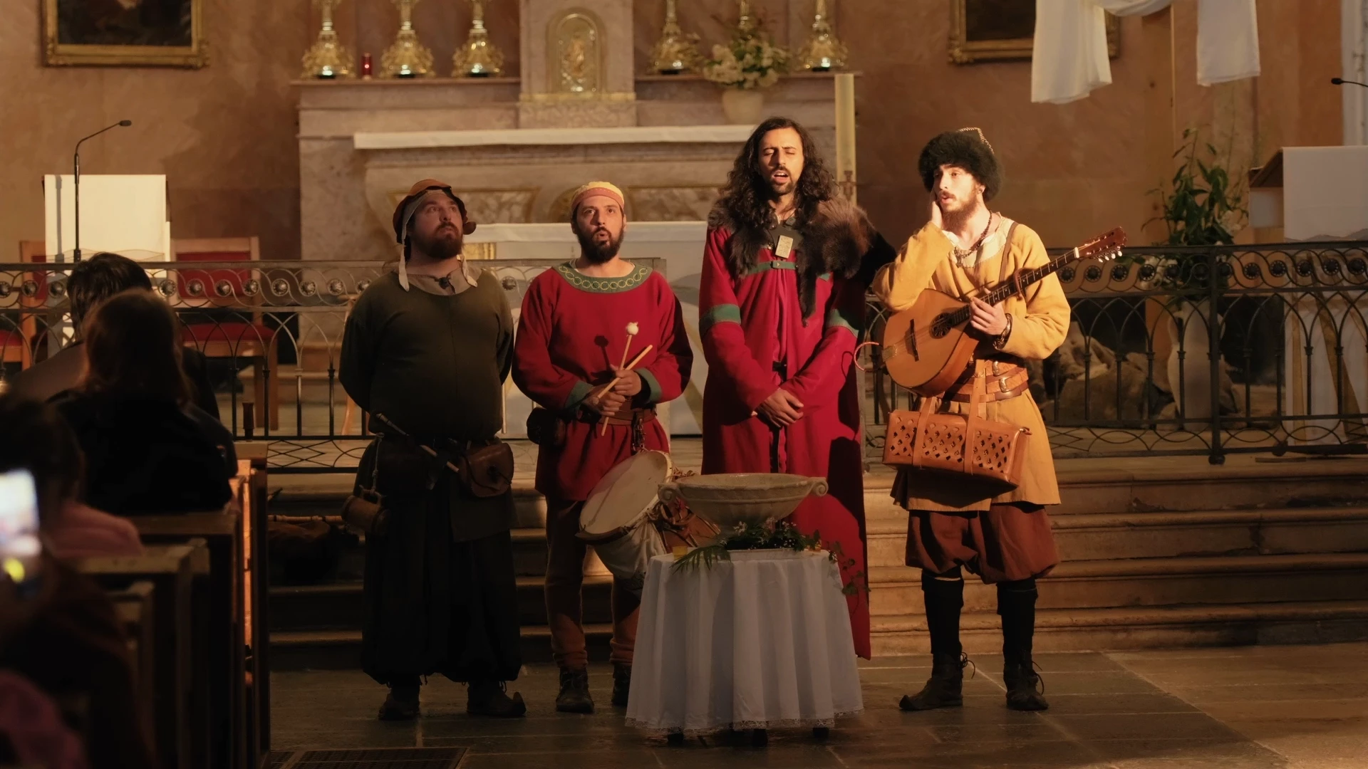 photo de 4 membres du groupe de musique médiévale Caminaaire chantant dans une église