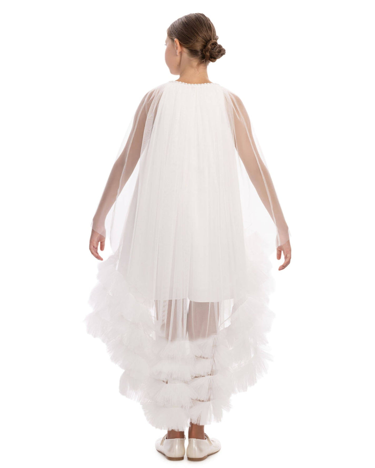 White dress with sheer sleeves and ruffled bottom on a white background